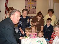  Larry Dunster presents the birthday cake to keturah and some eager family members.